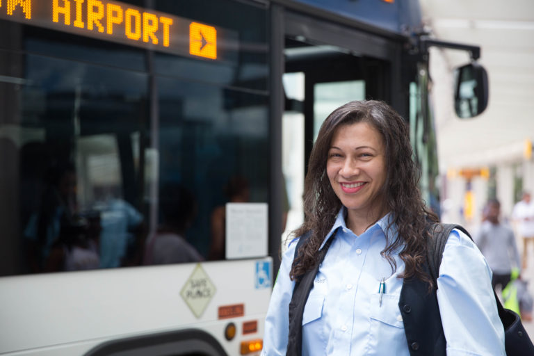 IndyGo Drive smiles in front of the bus he drives.