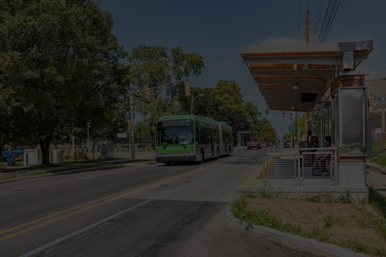 90 red line indygo rapid bus drives by a bus stop