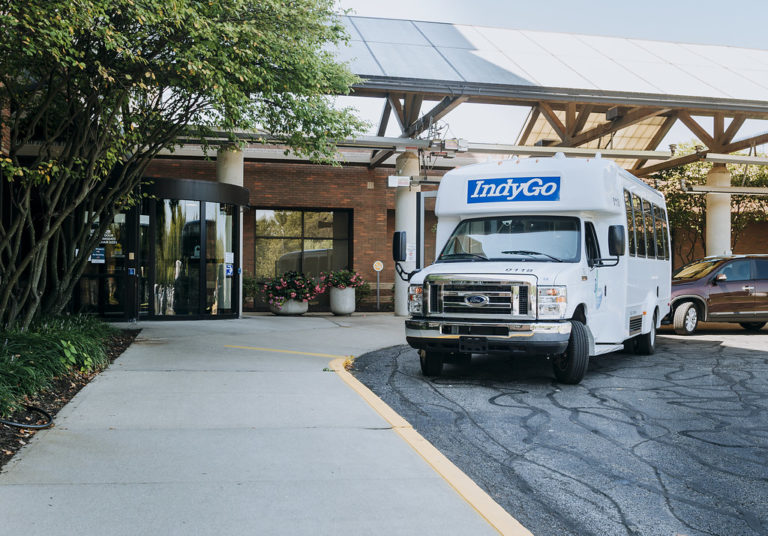 indygo van in front of building entrance